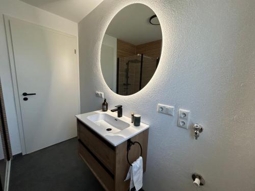 a bathroom with a sink and a mirror at Haus 11 in Oberkirch