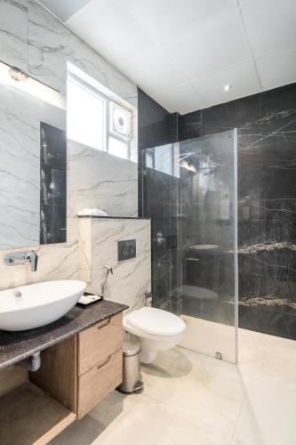 a bathroom with a sink and a toilet and a shower at Rudra Imperial Resort in Sītāpur