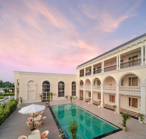 an exterior view of a building with a swimming pool at Rudra Imperial Resort in Sītāpur