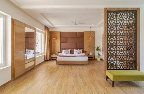 a hotel room with a bed and a window at Rudra Imperial Resort in Sītāpur