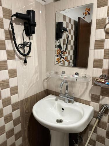 a bathroom with a sink and a mirror at Hotel Everest Nepal in Kathmandu