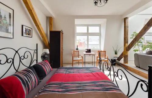a bedroom with a bed with a red blanket at Lenka's cozy Red studio + Lenka's cozy Gold apartment in Prague