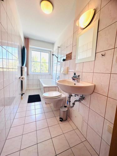 a bathroom with a sink and a toilet at Ferienwohnung Johanngeorgenstadt in Johanngeorgenstadt