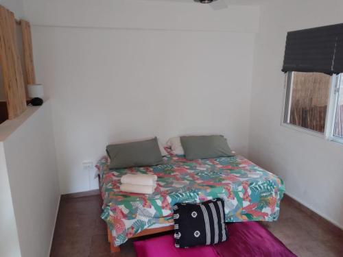 a small bedroom with a bed with a bag on it at NEW MORINGA in Las Terrenas