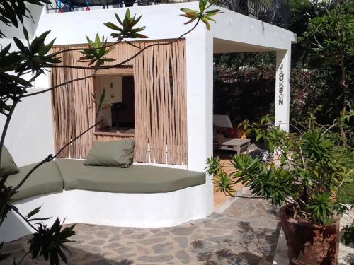 a gazebo with a couch in a garden at NEW MORINGA in Las Terrenas