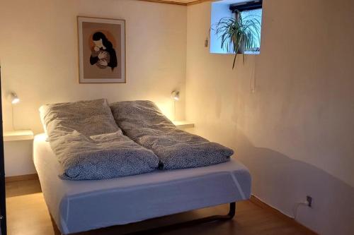 a bed sitting in a room with at Cozy cottage in Klaksvík