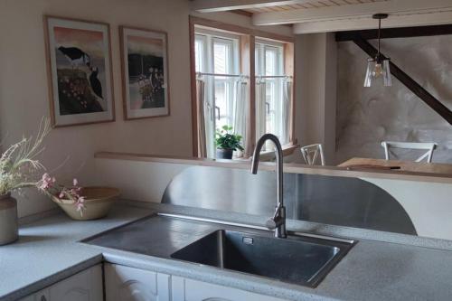 a kitchen with a sink and a counter top at Cozy cottage in Klaksvík