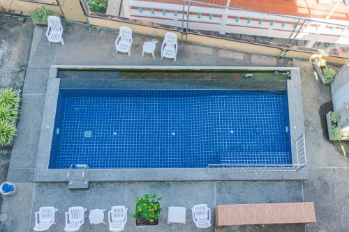 an overhead view of a swimming pool with lawn chairs at Pailin Hill Hotel Patong in Patong Beach