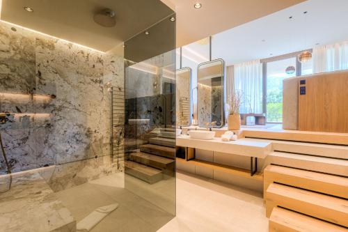 a bathroom with a sink and a shower at Boutique Hotel AMARIL in Castelbello-ciardes