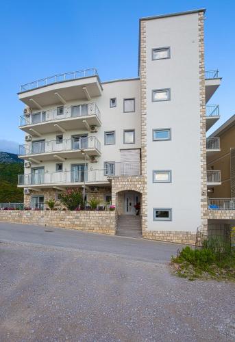 an apartment building on the side of a road at Montelux Apartments in Budva