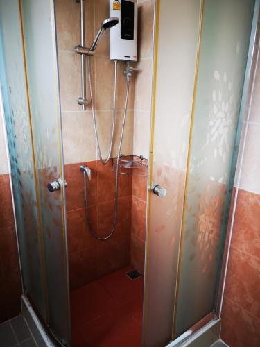 a shower stall in a bathroom with a shower at Baanchomchan in Hua Hin