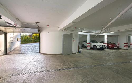 an empty parking garage with cars parked in it at Montelux Apartments in Budva