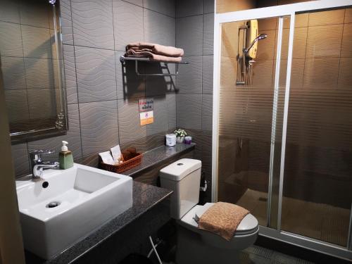 a bathroom with a sink and a toilet and a shower at Baanchomchan in Hua Hin