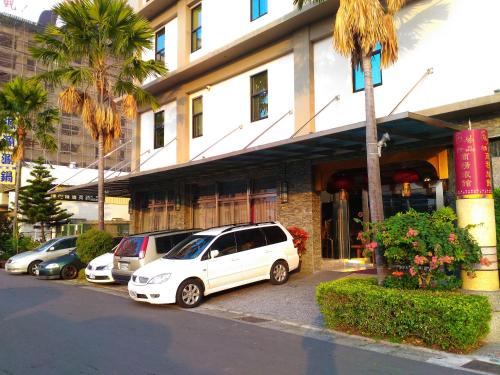 a group of cars parked in front of a building at Wei Feng Hotel - Kaohsiung in Nanzi