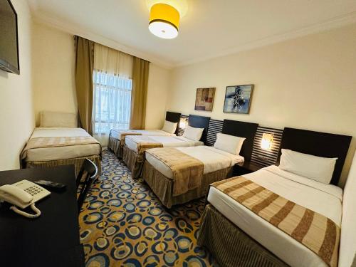 Postel nebo postele na pokoji v ubytování Saif Al Majd Hotel