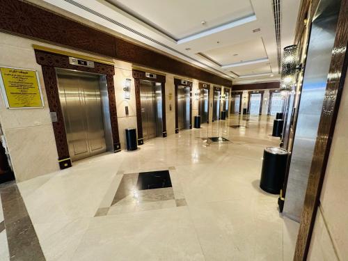 a hallway of a building with doors and ailed floor at Saif Al Majd Hotel in Makkah
