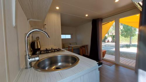 a bathroom with a sink in a tiny house at Camping Bella Vista in Ceriale