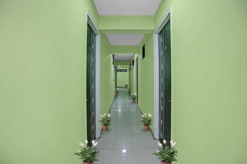 an empty hallway with potted plants in a building at OYO Flagship 88302 Shyam Residency Near Lotus Temple in New Delhi