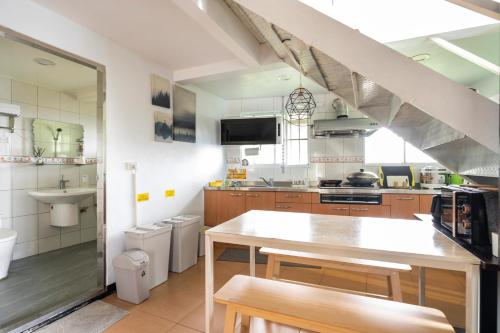 a large kitchen with a table and a sink at 歐森View包棟Villa x 雲海夜景 x 獨立空間 in Dongshi