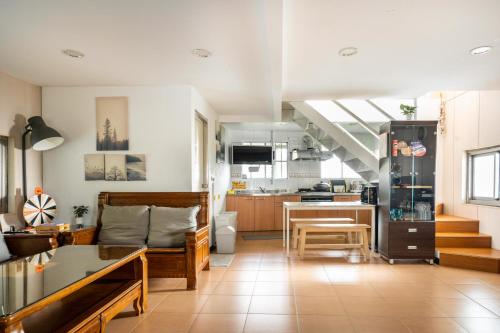 a living room with a table and a kitchen at 歐森View包棟Villa x 雲海夜景 x 獨立空間 in Dongshi