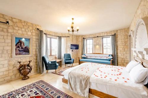 a bedroom with a bed and a desk and chairs at Castle Panorama House in Nevsehir