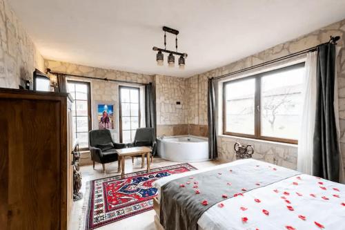 a bedroom with a bed and a tub in a room at Castle Panorama House in Nevsehir