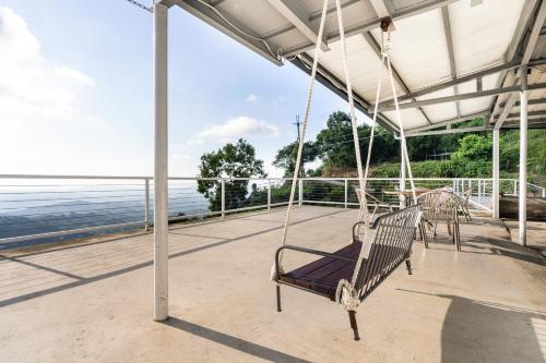 a swing on a porch overlooking the water at 歐森View包棟Villa x 雲海夜景 x 獨立空間 in Dongshi