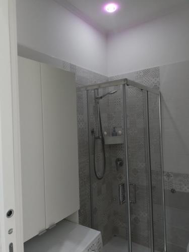 a bathroom with a shower with a glass door at LA CASA DEL RIONE SANITA’ in Naples