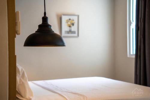 a bedroom with a black lamp and a bed at Windmill Upon Hills Premium Suite By Rapi Stay in Genting Highlands