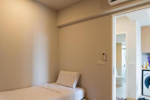 a small room with a bed and a mirror at Windmill Upon Hills Premium Suite By Rapi Stay in Genting Highlands