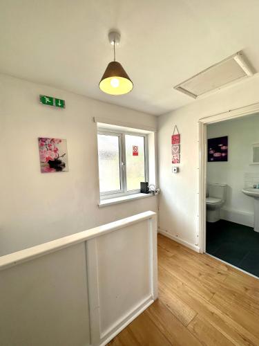 an empty room with a toilet and a window at Langdale House 5 bedroom 7 beds 3 bathrooms in Derby