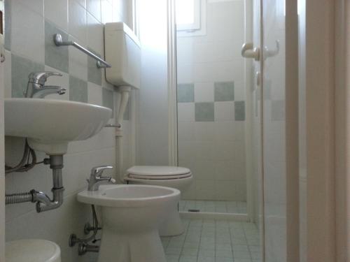 a bathroom with a sink and a toilet and a shower at Hotel La Parigina in Cesenatico