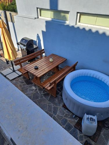 a patio with a grill and a table and a tub at Caveromane 2 in Pula