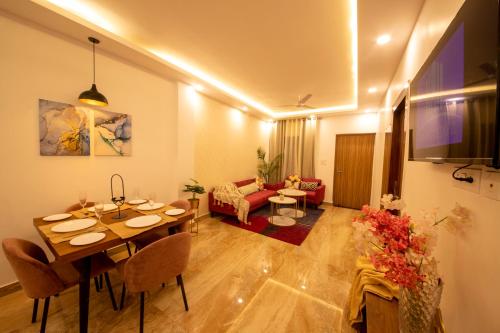 a living room with a table and a couch at Perfectstayz Value Homes Mussoorie 120 meters uphill in Mussoorie