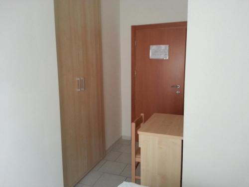 a small room with a desk and a door at Hotel La Parigina in Cesenatico
