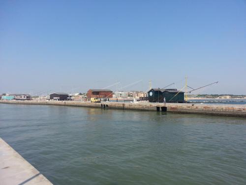 a large body of water with buildings and windmills at Hotel La Parigina in Cesenatico