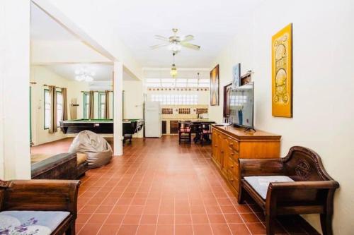 a living room with a tv and a pool table at The Rain tree, Pool villa Pattaya in Pattaya Central