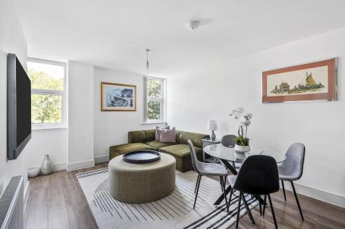 a living room with a couch and a table at Luxurious 2 Bedroom Apartment with Free Parking, Sky TV, Sports, Movies & Netflix in Chelmsford