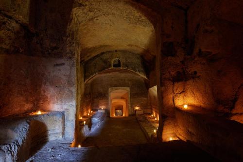 a dark tunnel with lights in a cave at Sextantio Le Grotte Della Civita in Matera