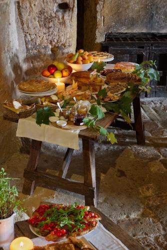 a table with many plates of food on it at Sextantio Le Grotte Della Civita in Matera