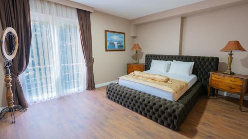 a bedroom with a bed and a large window at Gardan Hotel in Beylikduzu