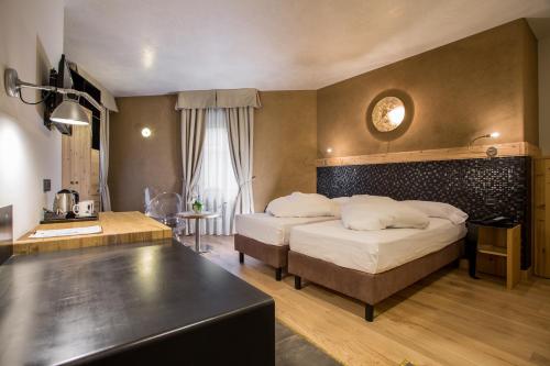 Ένα ή περισσότερα κρεβάτια σε δωμάτιο στο Hotel Orso Grigio
