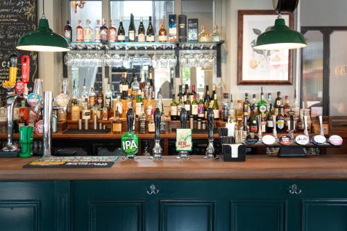 a bar with a lot of bottles of alcohol at Kew Gardens Hotel in Kew