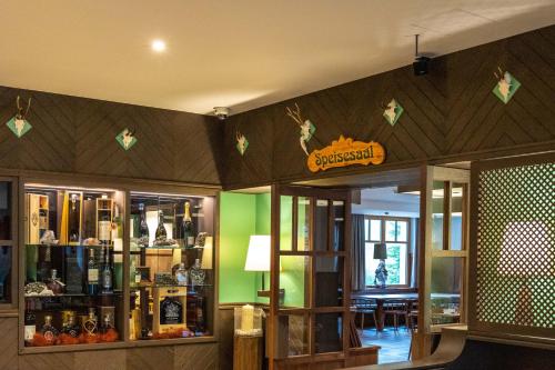 a store filled with lots of bottles of wine at Alpin Natur Hotel Brückele in Braies