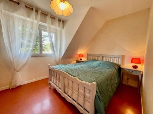 a bedroom with a white bed and a window at Appartement Quiberon, 3 pièces, 5 personnes - FR-1-478-75 in Quiberon
