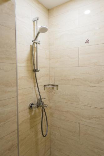 a shower with a shower head in a bathroom at Grand Hotel Sunny Beach - All Inclusive in Sunny Beach