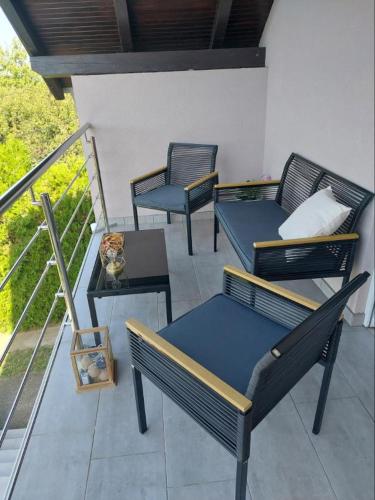 three chairs and a table on a balcony at Ivančica in Aljmaš