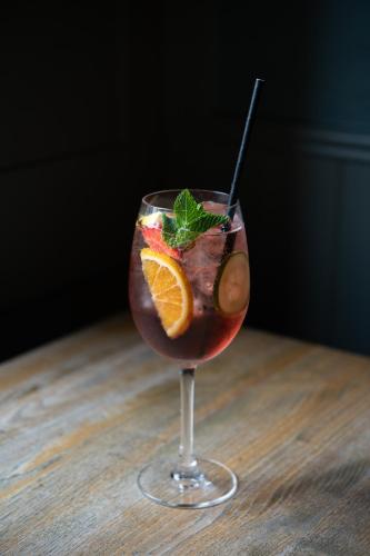 a drink in a glass with an orange slice at Kew Gardens Hotel in Kew