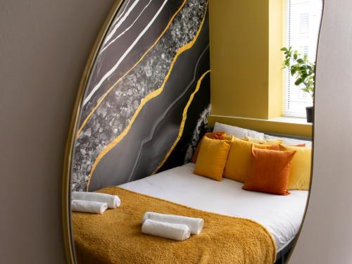 a bedroom with a bed in a mirror at Open Mind Property - Luxury Apartment in the City in Portsmouth
