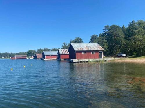 a row of houses on the water near a lake at Stugan in Lemland